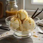 Close-up of creamy Vanilla Snow Ice Cream in a pastel-colored bowl, garnished with fresh berries and mint.